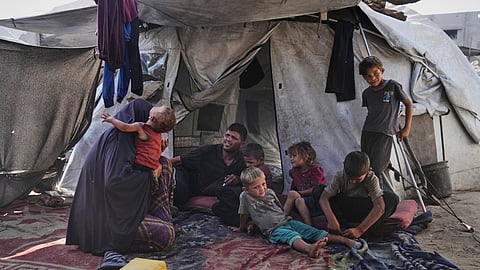 Abeer and Fadi Sobh gather in their tent with their children at a camp for displaced Palestinians in Gaza City, Thursday, July 24, 2025.