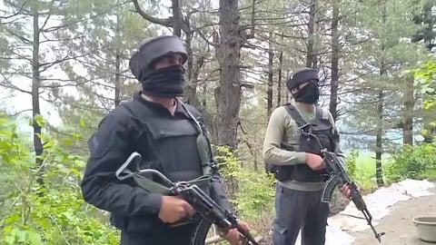 Security personnel stand guard amid an encounter with militants in Jammu and Kashmir.