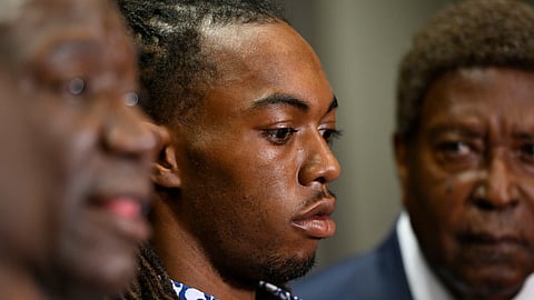 William McNeil Jr., center, looks on during a news conference Tuesday, July 29, 2025, in Chicago.