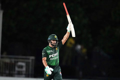 Pakistan's Sahibzada Farhan raises his bat after reaching a half century during the third Twenty20 cricket match against the West Indies, Sunday, Aug. 3, 2025, in Lauderhill, Fla.