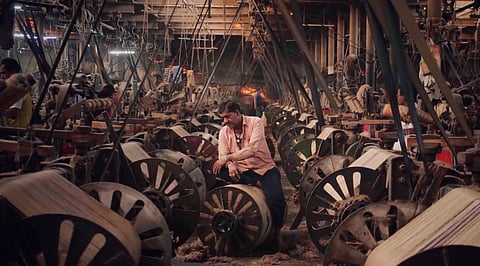 Workers at a mill. A still from the film. 