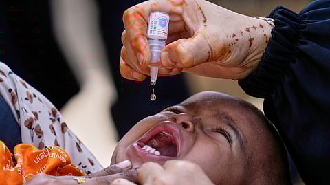 A health worker administers a polio vaccine to a child in Karachi, Pakistan, April 21, 2025.