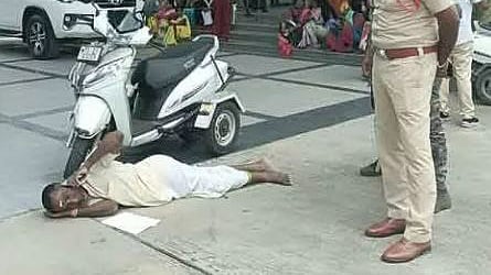 A person with disability, Raja Gangaram, lies down on the road in front of the Collector’s office to protest the negligence of authorities in Jagtial on Monday.
