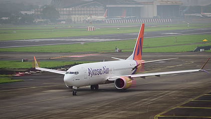 Passenger detained for trying to open emergency exit on flight.