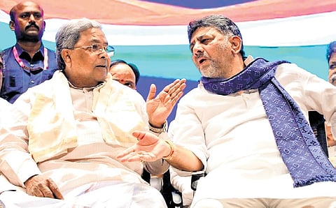 Chief Minister Siddaramaiah in conversation with Deputy Chief Minister DK Shivakumar at KPCC office in Bengaluru on Wednesday. 