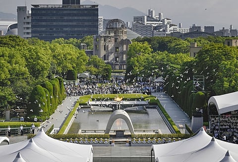 Doves fly over the cenotaph dedicated to the victims of the atomic bombing at the Hiroshima Peace Memorial Park during a ceremony to mark the 80th anniversary of the bombing in Hiroshima, western Japan, Wednesday, Aug. 6, 2025.
