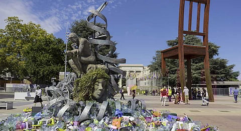 Plastic items are seen next to an artwork by Canadian artist and activist Benjamin Von Wong, titled 'The Thinker's Burden', a 6-meter-tall sculptural remix of Rodin's iconic Thinker, created especially for the Plastics Treaty negotiations, on Place des Nations in front of the European headquarters of the United Nations in Geneva, Switzerland, Monday, Aug. 4, 2025