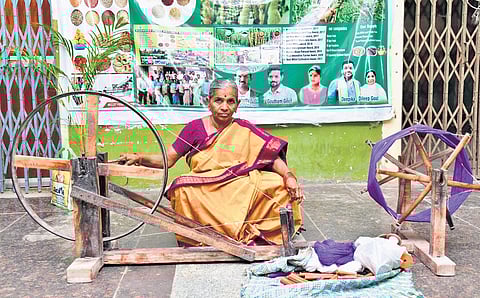 A weaver from Telangana showcases a ‘charkha’ at the Karimnagar collectorate on National Handloom Day, celebrated on Thursday.