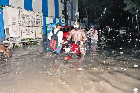 Motorists navigate a waterlogged road in Khairatabad on Thursday
