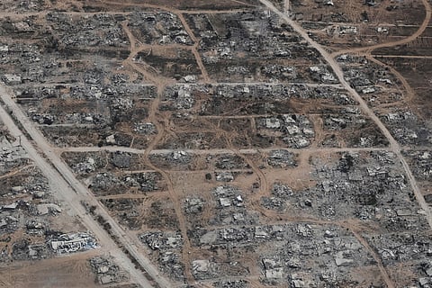 Destroyed buildings in the Gaza Strip are seen from a Jordanian Air Force C-130 plane during an airdrop of humanitarian aid for Palestinians, Thursday, Aug. 7, 2025.
