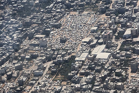 A tent camp in Gaza City is seen from a Jordanian Air Force C-130 plane during an airdrop of humanitarian aid for Palestinians on the Gaza Strip, Thursday, Aug. 7, 2025.