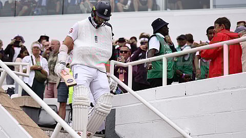England's Chris Woakes walks onto the pitch to bat on the fifth and final day of the fifth Test cricket match between England and India at The Oval in London on August 4, 2025.