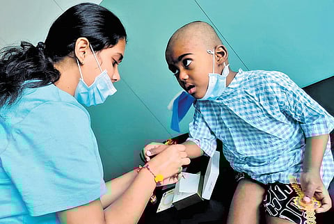 Hashmitha ties a rakhi around the wrist of her brother, Bharath, on Saturday