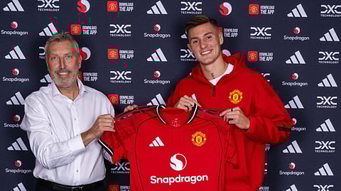 Slovenia forward Benjamin Sesko (R) poses with Manchester United's director of football, Jason Wilcox, at the club's Carrington training center after completing his transfer from RB Leipzig, Saturday, Aug. 9, 2025.