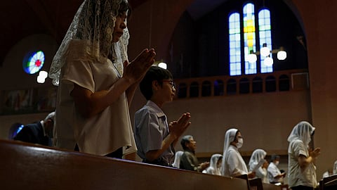 Faithful people offer prayers at the Urakami Cathedral in Nagasaki Saturday, Aug. 9, 2025, marking the 80th anniversary of the U.S. atomic bombing of the southwestern Japanese city.