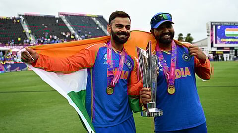 India's Virat Kohli and captain Rohit Sharma celebrate with the trophy after winning the ICC men's Twenty20 World Cup 2024 final cricket match between India and South Africa at Kensington Oval in Bridgetown, Barbados, on June 29, 2024. 