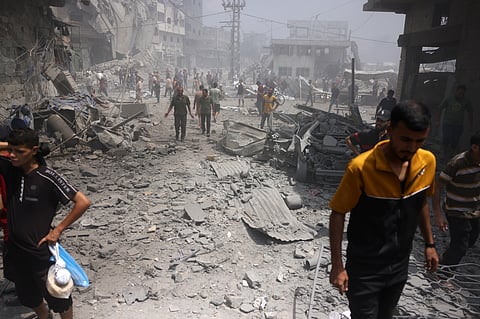 Palestinians check the devastation following an Israeli strike that hit Gaza City's southern al-Zeitoun neighbourhood on August 8, 2025.