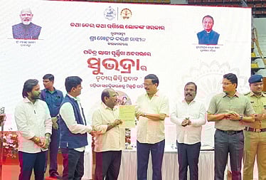 Revenue minister Suresh Pujari handing over RoR to a beneficiary in Cuttack 