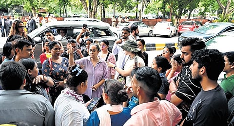 Dog lovers gather outside Supreme Court to protest the directive.