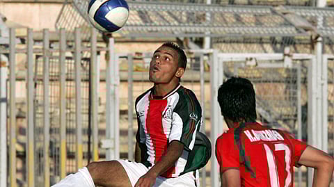 Palestinian player Suleiman Obeid (L) vies for the ball with Iranian player Hashem Beikzadeh during their West Asian Football Federation Championship (WAFF) match in the Jordanian capital Amman, 20 June 2007. 