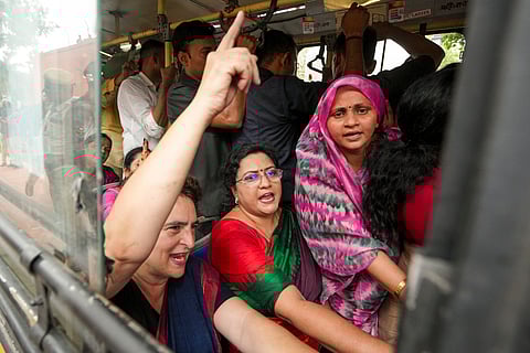 Congress MP Priyanka Gandhi Vadra with others being detained during a protest march by INDIA bloc MPs from Makar Dwar of Parliament to the Election Commission of India. 