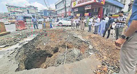 Kerala Road Fund Board workers at the road at Kacherithazham where a crater appeared recently. The stretch comes under the section being repaired by the board 
