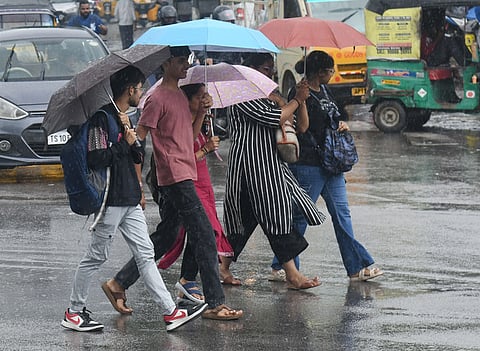 Students were seen reaching their destinations in Drizzle while protecting themselves with umbrella in Hyderabad.