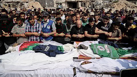 Palestinians pray over the bodies of journalists, including Al Jazeera correspondents Anas al-Sharif and Mohamed Qreiqeh, who were killed in an Israeli airstrike, during their funeral outside Gaza City's Shifa hospital complex, Monday, Aug. 11, 2025. 