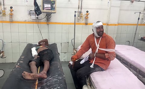 Injured people undergo treatment at a hospital after a collision between a pick-up van and a container truck on the Dausa-Manoharpur highway, in Rajasthan, Wednesday, Aug. 13, 2025.