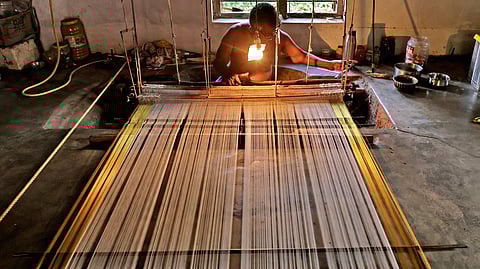 Mohanan N at work on a saree to be delivered for the Onam sales.