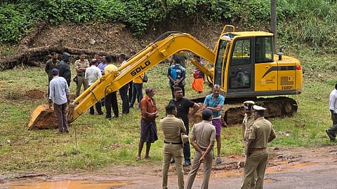 Heavy excavation equipment, including a large earthmover and a smaller digging machine, was being used for the excavation.