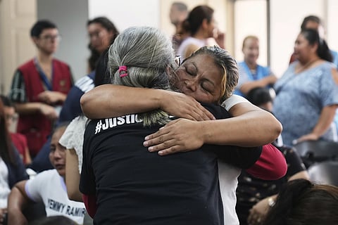 Relatives of the 41 girls killed in a fire at a government-run facility for at-risk girls in 2017, embrace in a courtroom during a hearing for seven people accused of responsibility, in Guatemala City, Tuesday, Aug 12, 2025.
