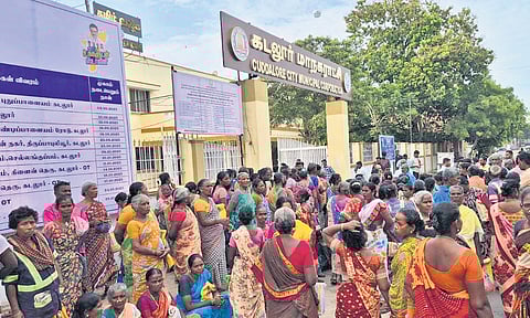 Sanitation staff stage protest in front of Cuddalore corporation office on Thursday demanding disbursement of pending salary of three months