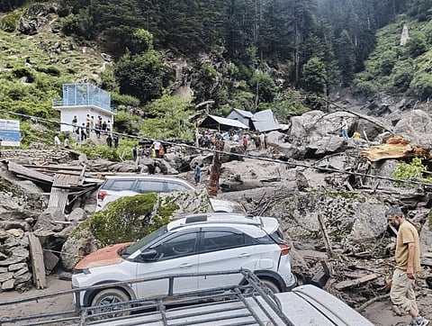 People move through the debris after a massive cloudburst at Chasoti village, in Jammu and Kashmir's Kishtwar district, Thursday, Aug. 14, 2025. At least 38  people were killed in the incident, according to officials. Chasoti is the last motorable village on the way to the Machail Mata temple. 