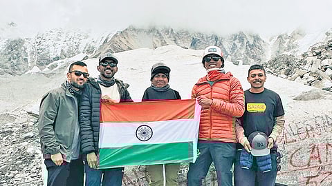 Aman and his team pose with the national flag near the Everest Base Camp