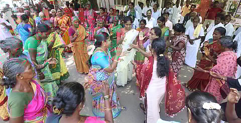 Members of 18 kirama makkal kootamaipu [federation representing 18 village communities] in Melur perform kummi songs in front of the Collector office.