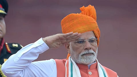 Prime Minister Narendra Modi stands for the national anthem after hoisting the national flag during the 79th Independence Day celebration at the Red Fort, in New Delhi, Friday, Aug. 15, 2025.