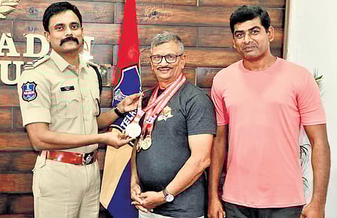 Bhadradri Kothagudem Superintendent of Police Rohit Raj felicitates Sankara Rao along with his coach Gogidi Venkata Rami Reddy on Saturday