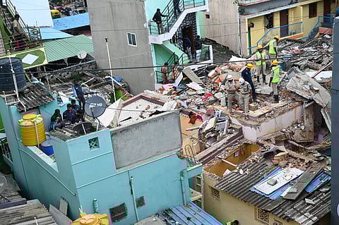 SDRF personnel and firefighters inspect the blast site in Wilson Garden, Bengaluru, on Friday 