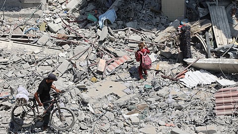 Palestinians walk over rubble and debris in the al-Tuffah neighbourhood of Gaza City.