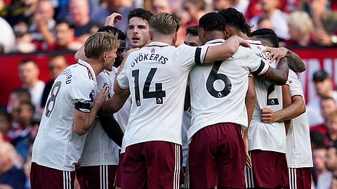 Arsenal players celebrate after scoring against Manchester United during the English Premier League soccer match at Old Trafford stadium in Manchester, England, Sunday, Aug. 17, 2025.