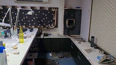 Broken safe and goods strewn across the floor in the main chamber of the factory in Kapodra, Surat.