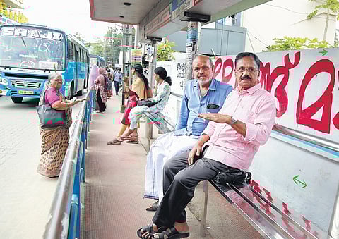 Consumer rights activist Tilakan and ward councillor C Nandakumar at a Kodungallur bus stand with newly-installed seating. 