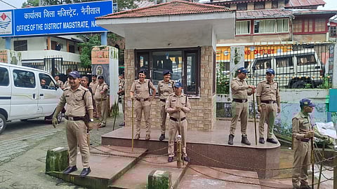 Police stationed outside the District Magistrate's Office in Nainital.