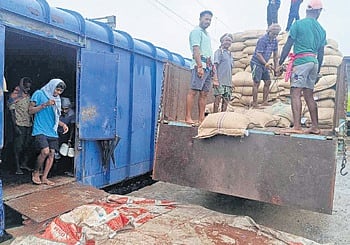 Bags of ragi being loaded onto a train at Jeypore railway station 