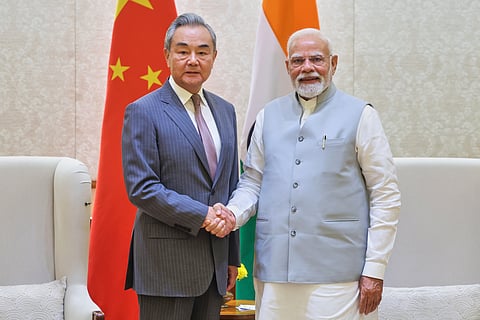 Indian Prime Minister Narendra Modi, right, shakes hand with Chinese Foreign Minister Wang Yi, left, in New Delhi, India, Tuesday, Aug.19, 2025. (Indian Prime Minister's Office via AP)
