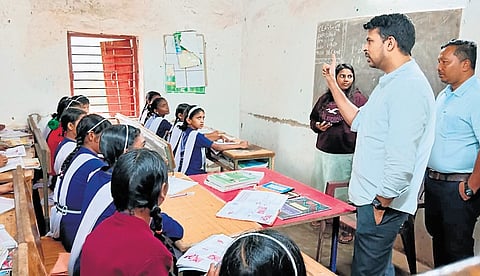 Malkangiri collector Somesh Kumar Upadhyay teaching students of Classes VII & VIII at Government SSD Girl’s High school in Mudulipada of Bonda Hill 