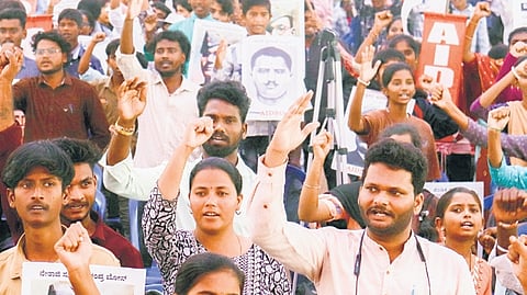Members of AIDSO protest against the move to close government schools at Freedom Park on Thursday