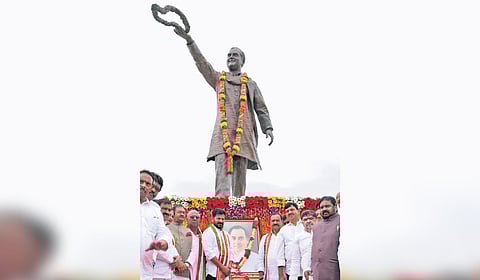 Chief Minister A Revanth Reddy pays floral tribute to late prime minister Rajiv Gandhi at his statue in front of Secretariat on Wednesday