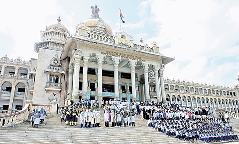 School students sit for a photo-op after attending a session  in Vidhana Soudha on Thursday 
